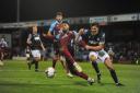 Connor Woods challenges Scunthorpe's Tyler Denton during Town's 1-0 defeat at Glanford Park