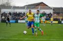 Josh Amis and former Town defender Tyrone Duffus battle for possession