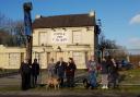 The group pictured outside of the former Burtonwood pub