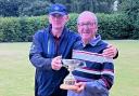 Dave Bennett, left, receives his prize from league chairman Colin Hart