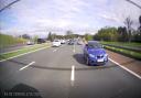 The driver was caught in a rear camera waving his arms out of the window