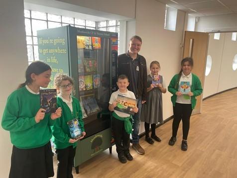 Meadowside Community Primary and Nursery School's new book vending machine was opened by local author, Rob Parker