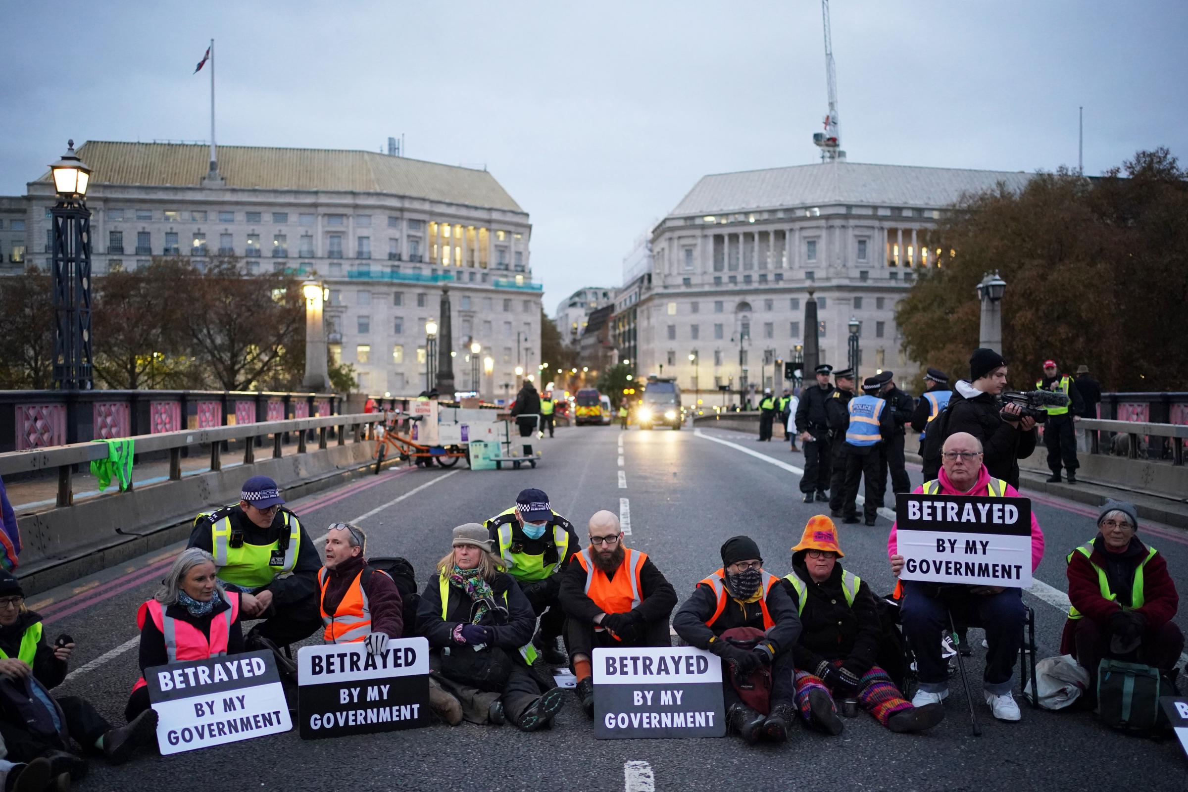 Supporters of the nine jailed Insulate Britain climate activists take part in a demonstration on Lambeth Bridge in central London. Picture date: Saturday November 20, 2021. PA Photo. The activists were jailed this week for breaching an injunction
