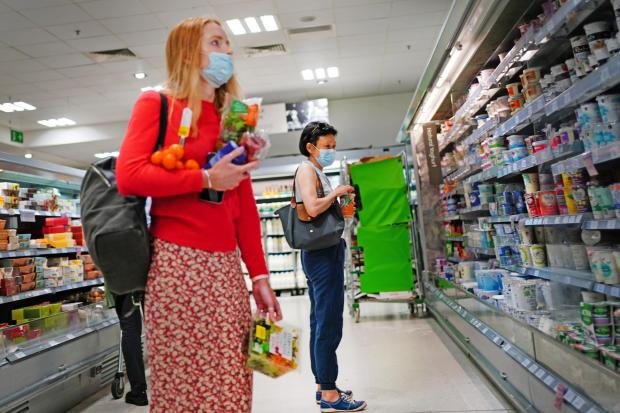 Warrington Guardian: Shoppers in a supermarket (PA)