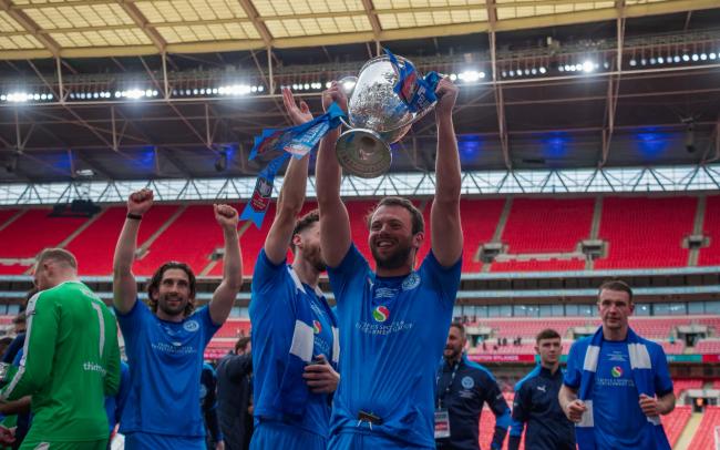 Ste Milne lifts the FA Vase for Warrington Rylands back in May. Picture by Mark Percy