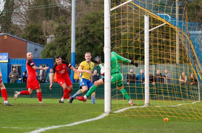 Mitch Duggan opens the scoring for Warrington Town against Bamber Bridge. Picture by Jonathan Moore