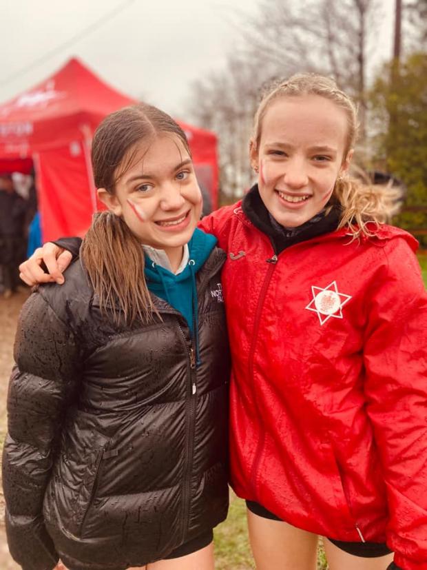 Warrington Guardian: Alice Nicholson, left, who finished fourth while wearing only one show in the 2022 Cheshire Cross Country Championships under 15s girls' race at The Farm Club in Pickmere on Saturday. She is with clubmate Imogen Wharton, right, who won the race 