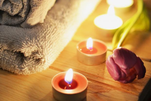 Warrington Guardian: A pile of towels, candles and a tulip. Credit: Canva