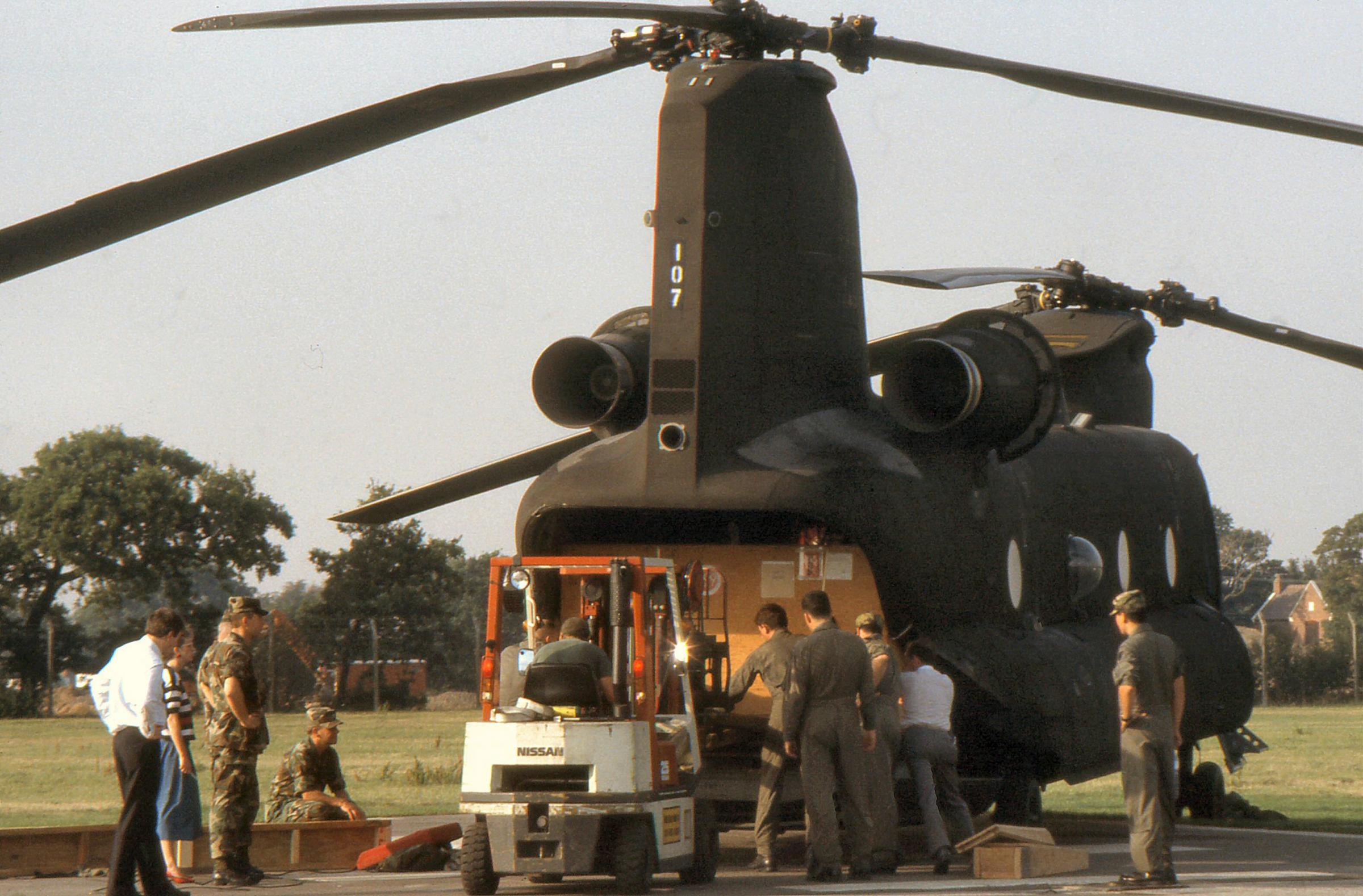 Supplies are loaded onto a Chinook helicopter to transport ultimitely to assist the First Gulf War effort