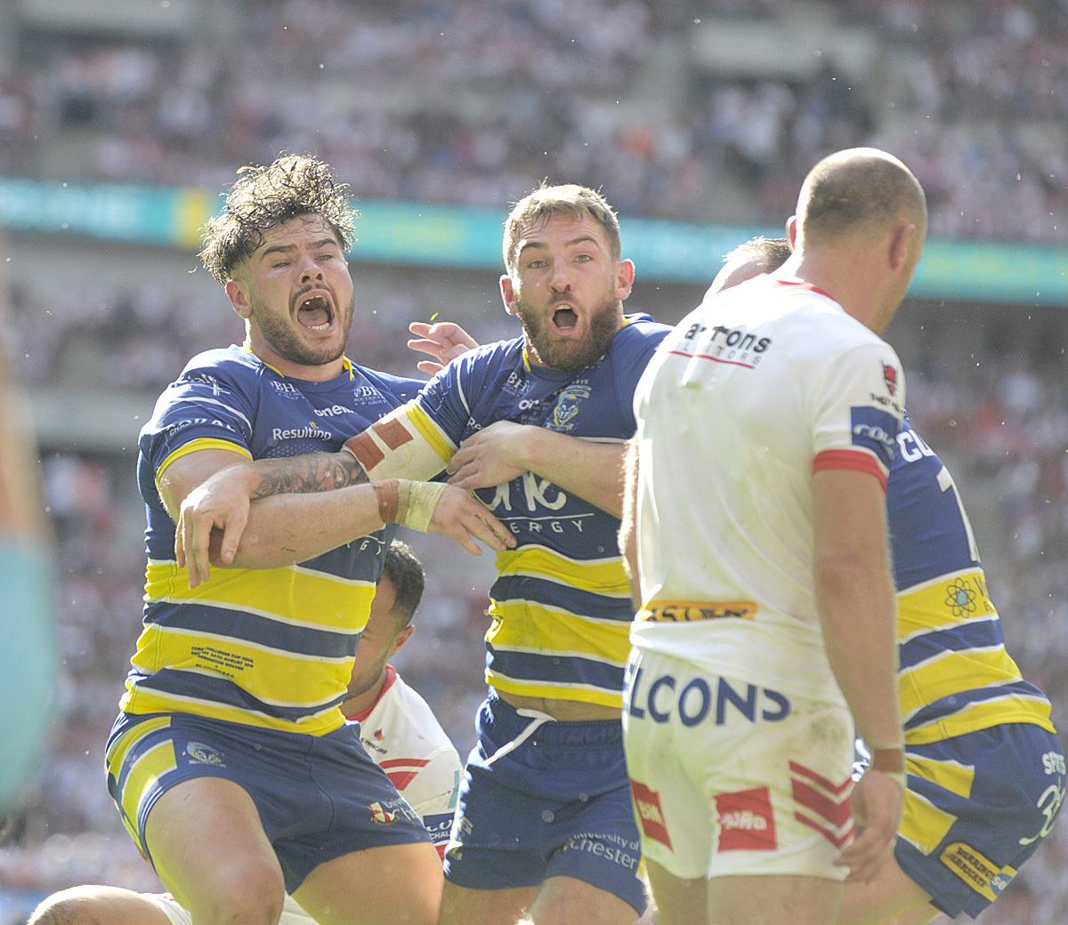 Daryl Clark is joined by Joe Philbin to celebrate the formers try in the 2019 Challenge Cup Final win over Saints. Picture by Mike Boden