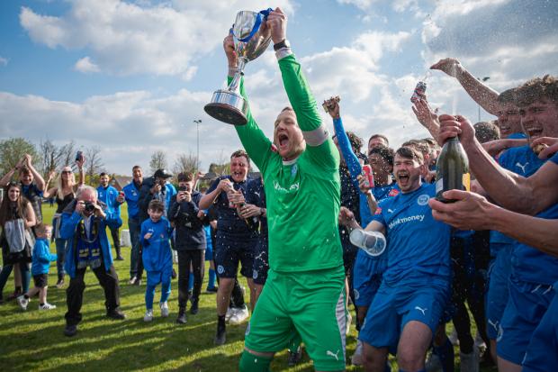 Warrington Rylands skipper Graeme McCall lifts the NPL West title. Picture by Mark Percy