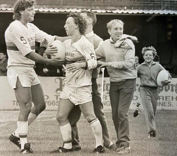 Warrington Guardian: Fans join in the celebrations after this try by Paul Bishop, who is congratulated by Rick Thackray