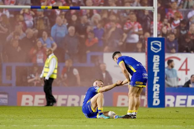 A dejected Oliver Holmes is helped to his feet by Joe Philbin at full time. Picture by PA Wire