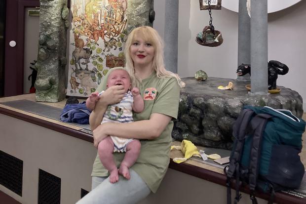 Multimedia artist Anna with her baby Perrin alongside the work in progress