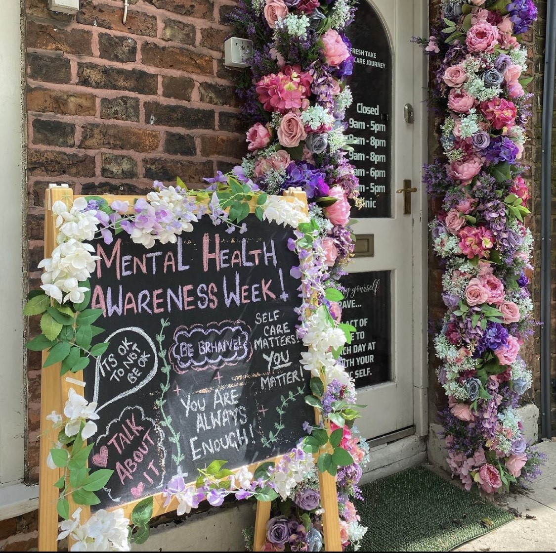 The entrance to the salon is an archway of flowers