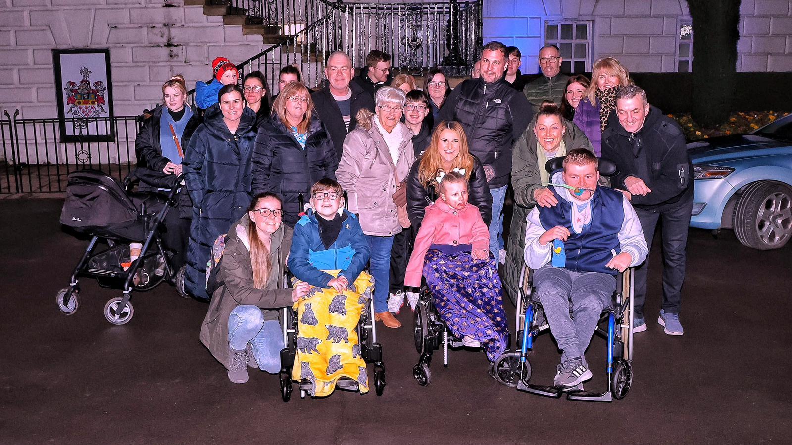 Families gathered outside the Town Hall on Wednesday evening to see it lit blue