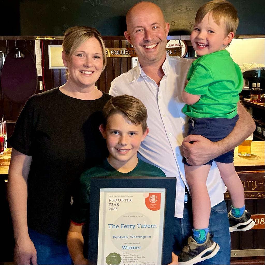 Andy and Jade Mulholland with their two children after winning their CAMRA award
