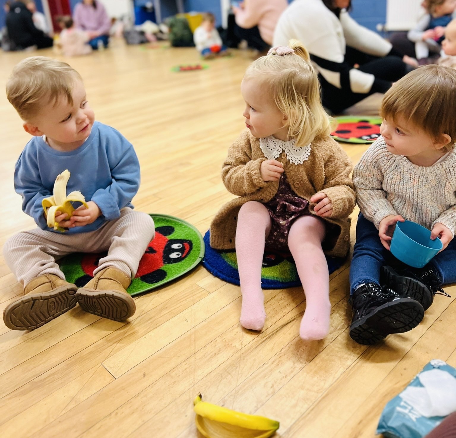 Little ones and their adults enjoy the social time at the end of each class
