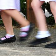 File photo date 15/07/14 of school girls walking to school. Children under the age of 16 accounted for 1% of coronavirus cases in the first peak of Covid-19 in England, a new study has concluded..