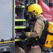 Firefighters wearing breathing apparatus tackle car fire in  Bewsey