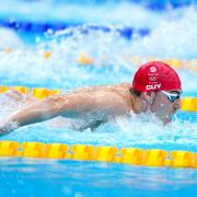 James Guy in action during the men's 4x100m medley relay heats. Picture by PA Wire