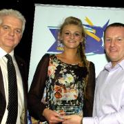 Abigayle Fitzpatrick receives her award from compere Bob Williams and sales manager Carl Baldwin, representing award sponsors Barclays Motorways