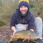 Michael Griffiths with a common carp he caught at The Mount