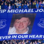 A surfer flag is held up in memory of Michael Jones, who died while working on the Bramley Moore Dock stadium build on the 15th August 2023, ahead of the Premier League match at Goodison Park, Liverpool