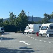 Traveller caravans on the car park of M&S in Gemini
