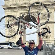 Cricketer Rob Jones celebrates completing his Paris to London cycle ride