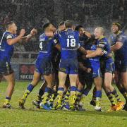 Chris Sandow is mobbed by his teammates after his match-winning drop goal. Picture by Paul Heaps