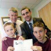 John Twiss, head of IT, Philip Cartwright from RM, Connor Radcliffe and Sean Brennan celebrate Penkford School's achievement DGD110408