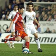 Liverpool's Xabi Alonso and United's Rodrigo Possebon in last year's clash at The Halliwell Jones