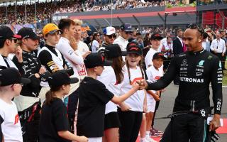 Luca Narraway fist-pumps with race star Lewis Hamilton at Silverstone