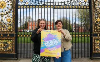 Amber Dawbler and Andrea Morley holding Warrington Music Month's poster