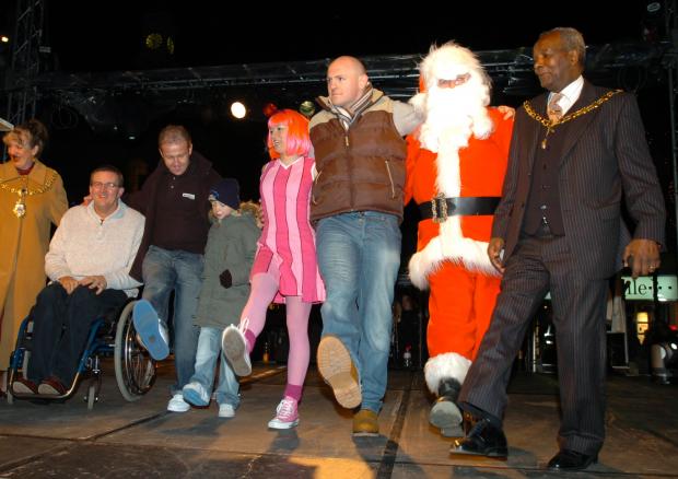 Warrington Guardian: Wire prop Rob Parker dancing with Santa at the Christmas lights switch-on in 2006